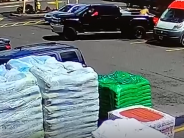 Security image of Ace Hardware parking lot with black Chevy pickup