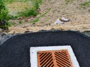 Multiple storm drains and manholes running down street and ditch for South 10th Street storm drain reroute project