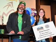 Mayor Scholl with Taylor Rosie Parsons holding balloons and sign announcing state winning