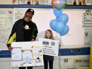 Mayor Scholl with Ellie Luke holding balloons and sign announcing state winning