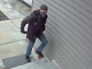 Second screen capture of front door security video of package thief walking up to front door