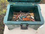 Miscellaneous tools inside a green toolbox 