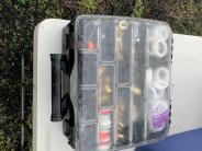 Fishing tackle box with clear lid and fishing gear inside 