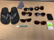 SHPD photo of miscellaneous recovered items including flip flops and multiple sunglasses
