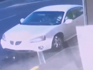 Suspect's vehicle pictured on surveillance camera outside business 