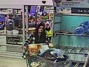 Female suspect one pushing shopping cart out of Walmart
