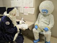 Abominable Snowman being booked in jail by Officer Claus