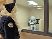 Abominable Snowman making a phone call while Officer Claus observes