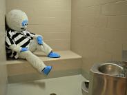 Abominable Snowman sitting in a jail holding cell
