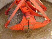 closeup view of the clam shovel digging out rock and mud.  Down, down, down each section goes.