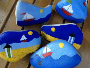 Rocks painted with ocean and beach scenes