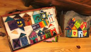 Miniature block houses painted and displayed for "This is Us" community art project