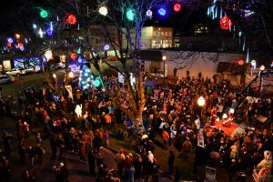 Columbia County Courthouse plaza square filled with people and holiday lights for the 2018 holiday tree lighting ceremony. 
