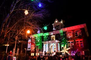 Columbia County Courthouse at night with holiday lights projected onto front of building