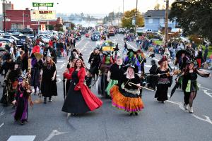 Spirit of Halloweentown 2019 parade with costumed dancers in witch outfits dancing down street