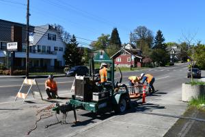 Construction crew in street right of way with equipment