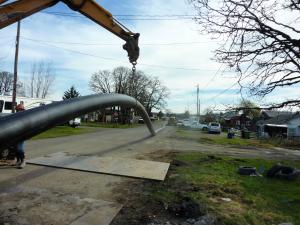 Construction equipment and storm drain line running down the middle of a street for the South 10th Street storm drain project 