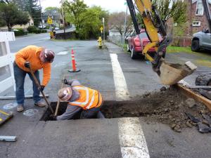 Contractors working in trench to install new water lines in St. Helens 