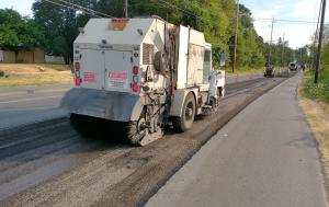 Construction equipment working on Old Portland Road paving overlay 