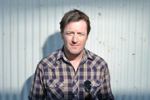 Press photo of author Willy Vlautin standing in front of white background 