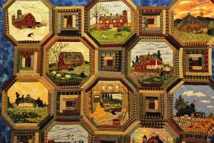 Close up of quilt with circular patterns and country scenes 
