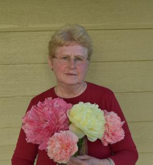 Carol Adelman holding pink and white peonies