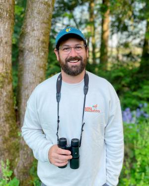 Tom Myers with binoculars outside