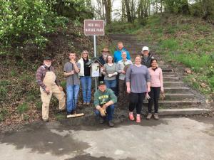 A group of volunteers standing in front of the Nob Hill Nature Park sign