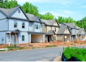 New homes mid-construction line a street 