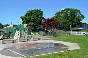 Columbia View Park during summer with playground structure, splash pad, gazebo and outdoor amphitheater.