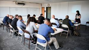 Brianne Mares stands in classroom in front of two rows of seated law enforcement officers teaching