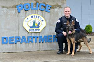 Photo of Officer Thompson and K-9 Ryder in front of the St. Helens Police Department