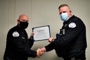 Chief Brian Greenway presenting Life Saving Award to Officer Adam Hartless 