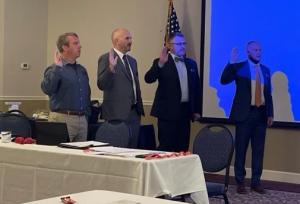 Lt. Hogue at far left is sworn in along with three other people at conference 