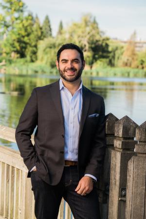 Professional photo of Mouhamad Zaher outdoors with trees and river in background 