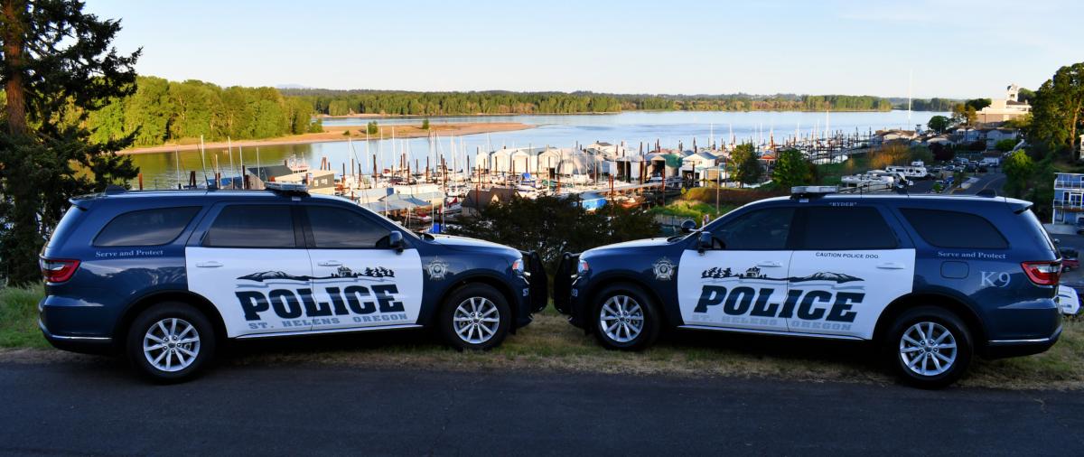 Two St. Helens patrol vehicles with St. Helens riverfront in background
