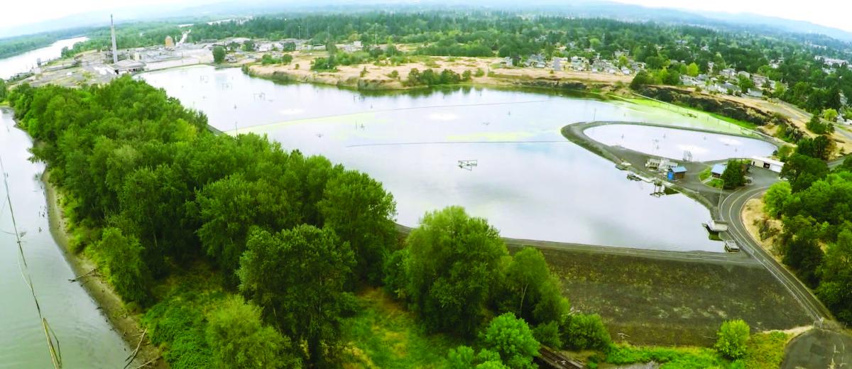 Aerial view of Central Waterfront property with wastewater lagoon visible 